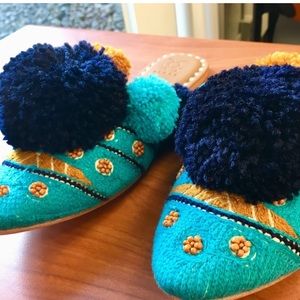Figue- Turquoise leather Iris slides with pom-poms and beading.